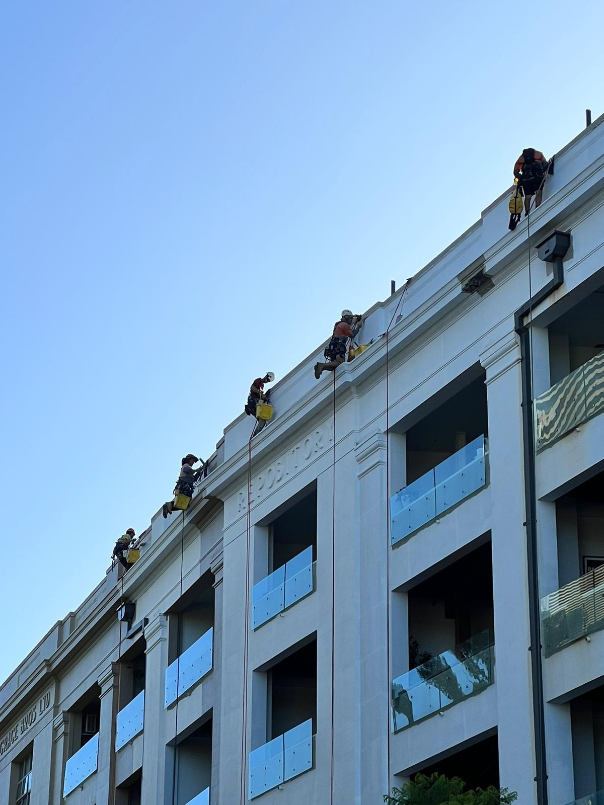 Practical Access Solutions rope-access crew working across a building facade